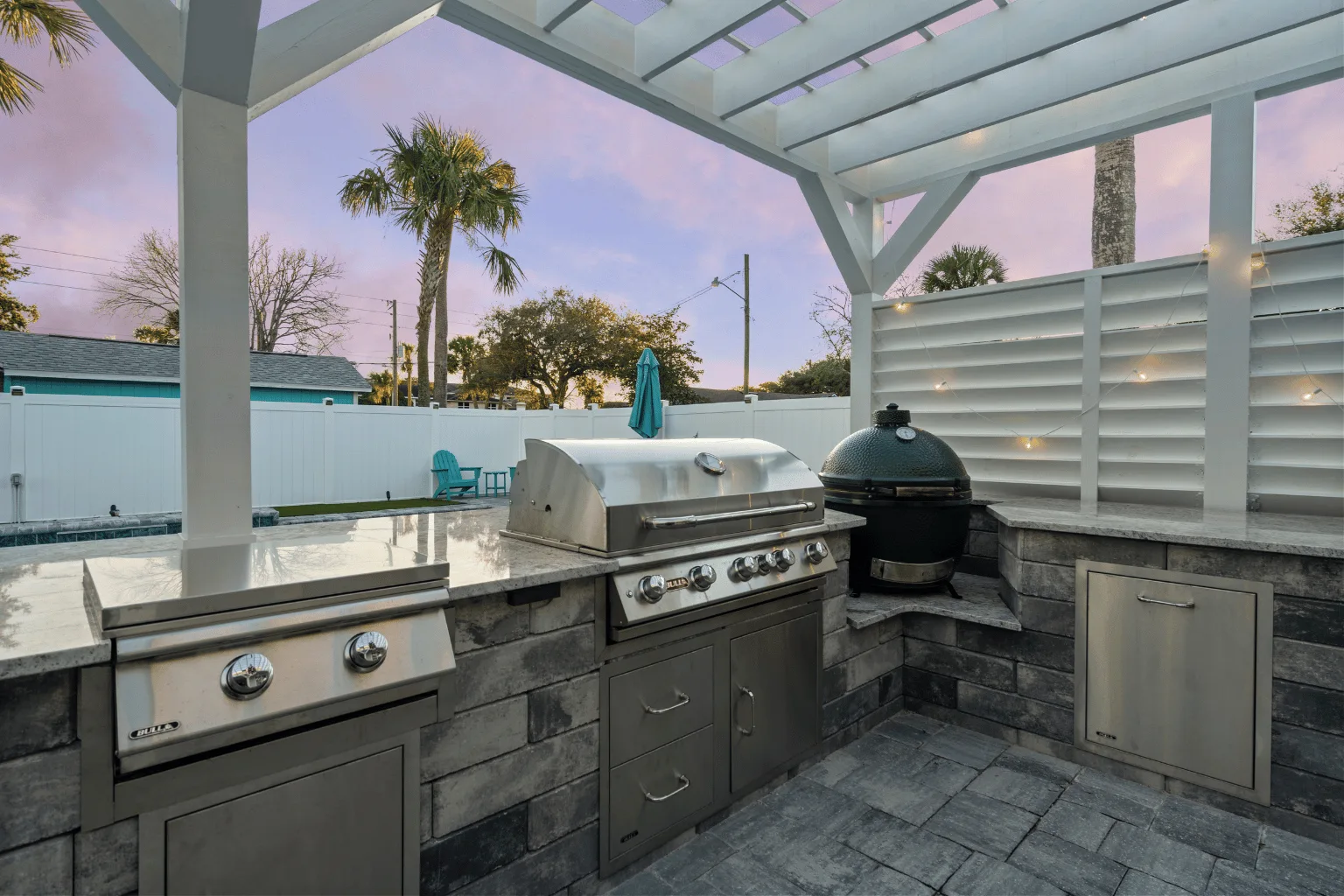 Outdoor kitchen and pergola installation with grill and kamado smoker by Jax Pavers in Jacksonville FL
