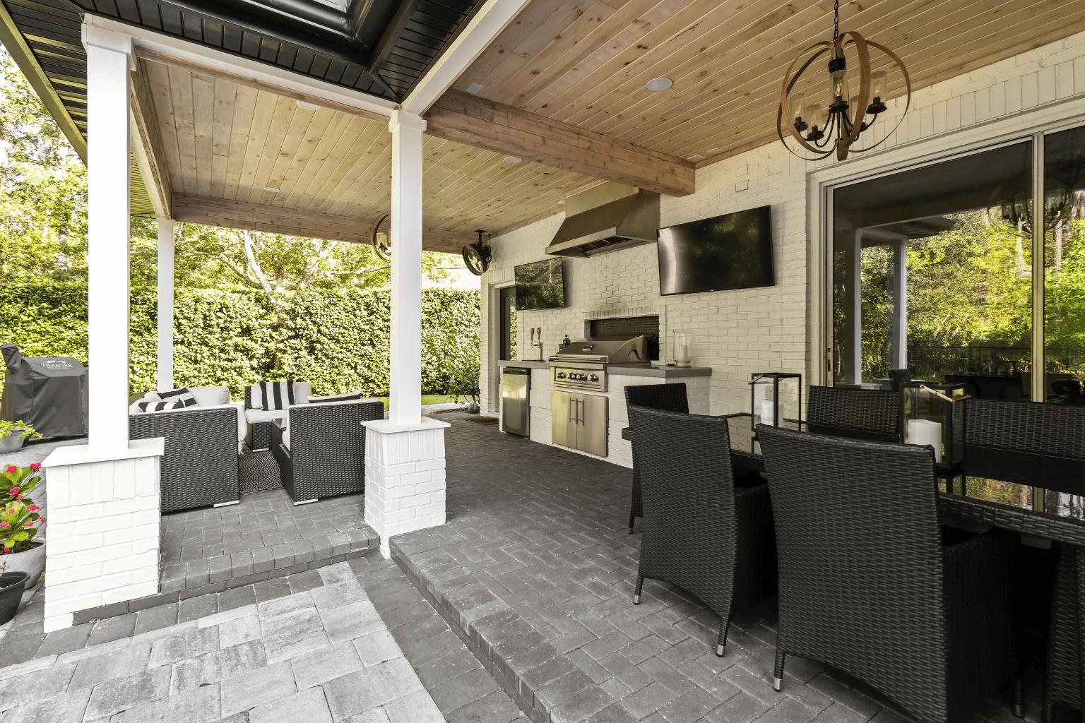 Custom outdoor kitchen installation with wood-plank ceiling and paver flooring by Jax Pavers in Jacksonville FL