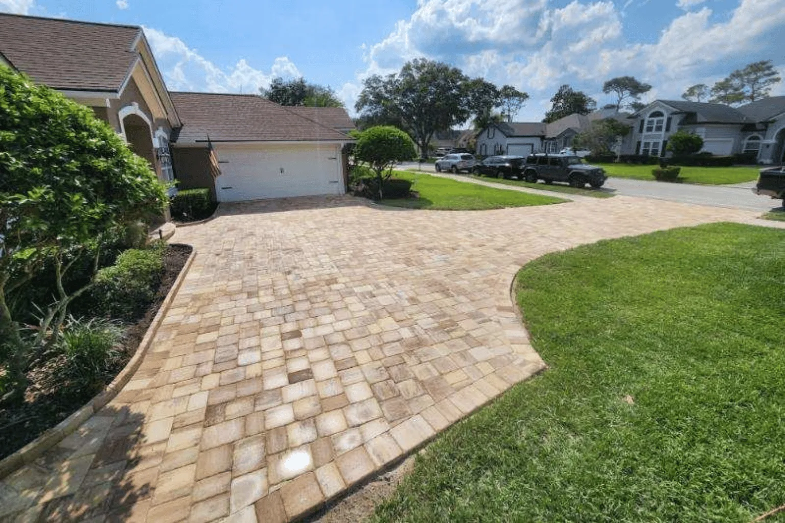 Tumbled paver driveway installation with curved border by Jax Pavers in Jacksonville FL