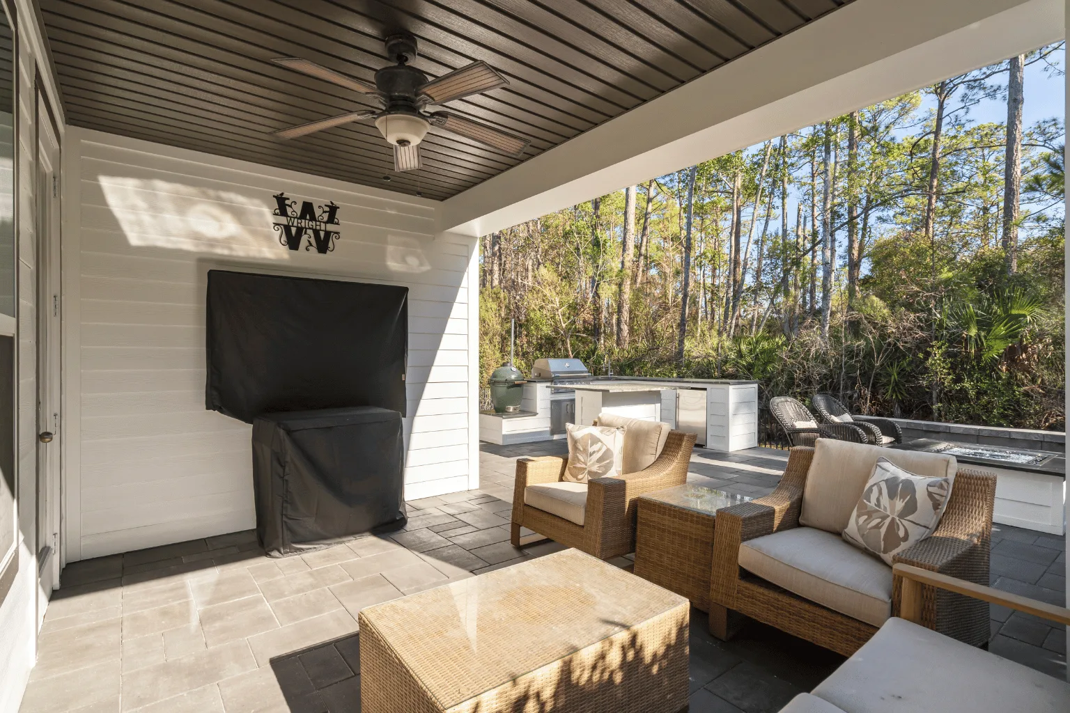 Covered outdoor living area installation with paver flooring and grill station by Jax Pavers in Jacksonville FL