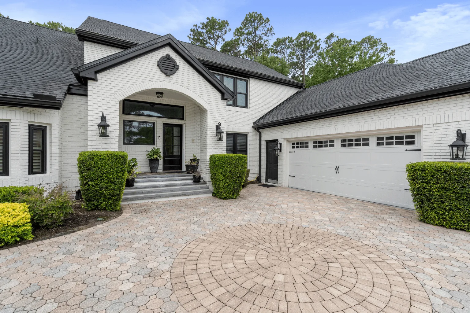 Circle medallion paver driveway installation at a three-car garage home by Jax Pavers in Jacksonville FL