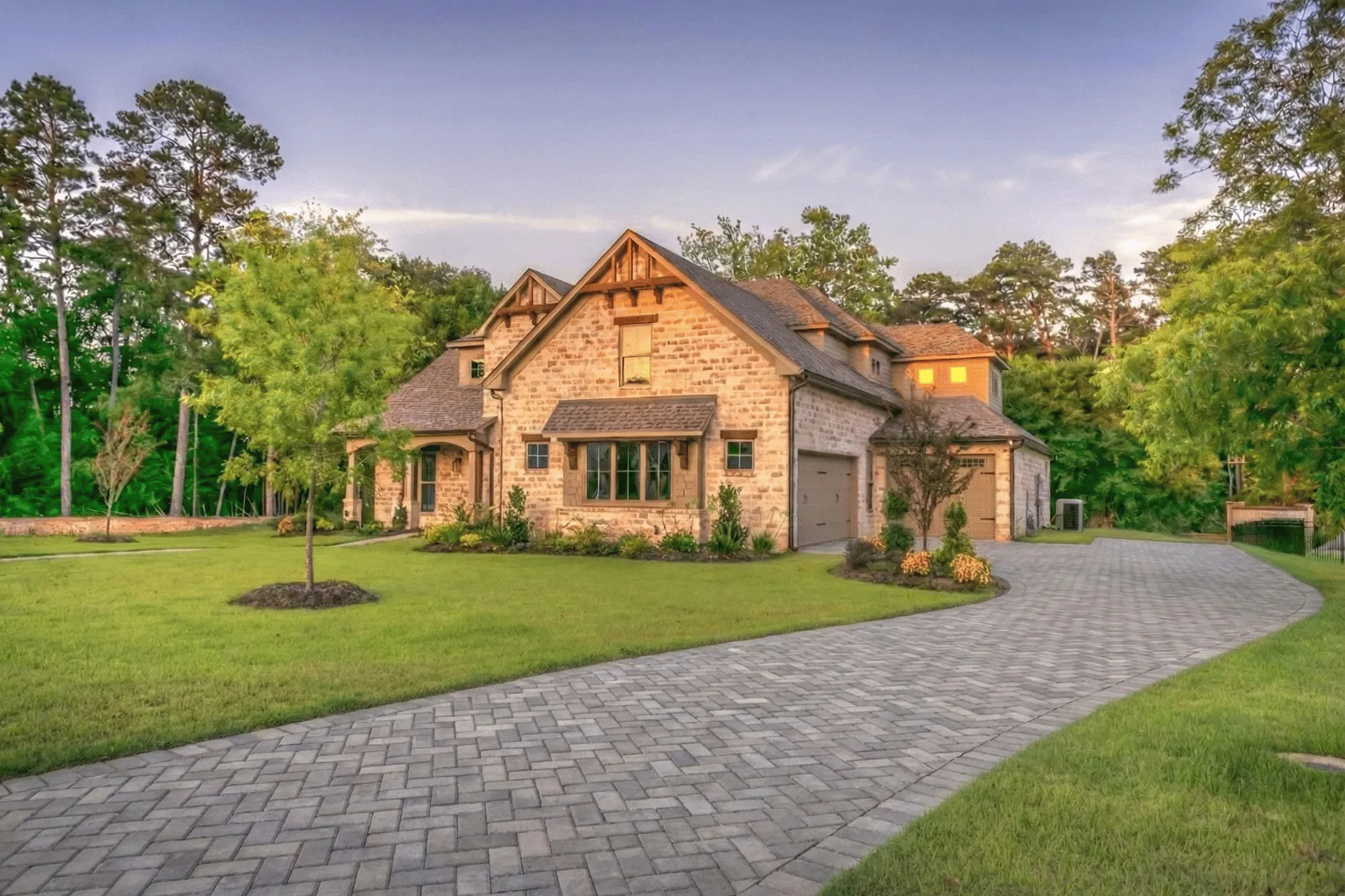 Paver driveway installation curving through a wooded estate lot by Jax Pavers in Jacksonville FL