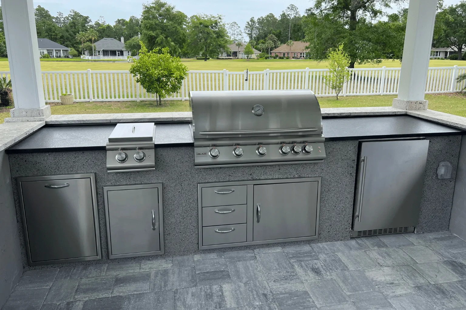 Outdoor kitchen island installation with grill, side burner, and pergola by Jax Pavers in Jacksonville FL